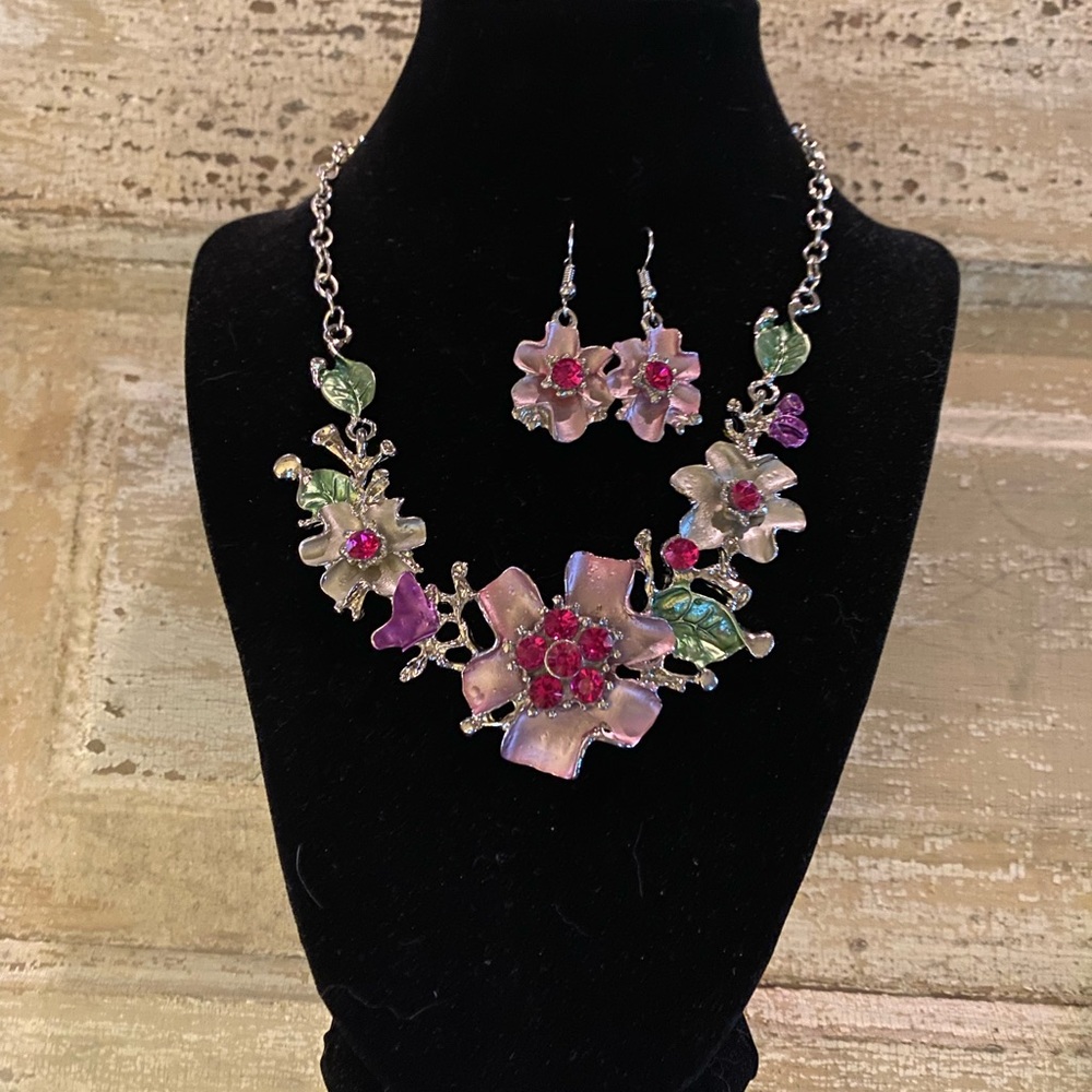 Elegant and Georgia’s metallic floral necklace and earrings with silver accents